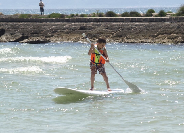  Little one learning sup in Mallorca 